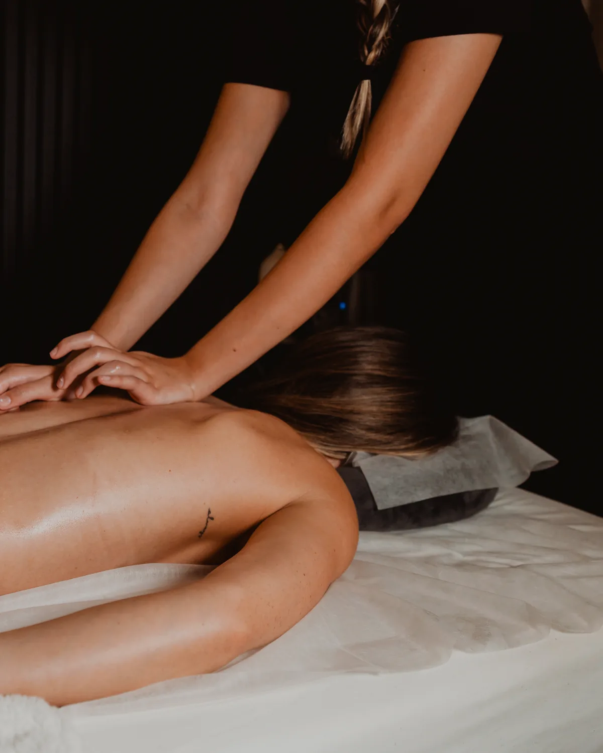 Tara Spa therapist applying firm massage pressure in a treatment room